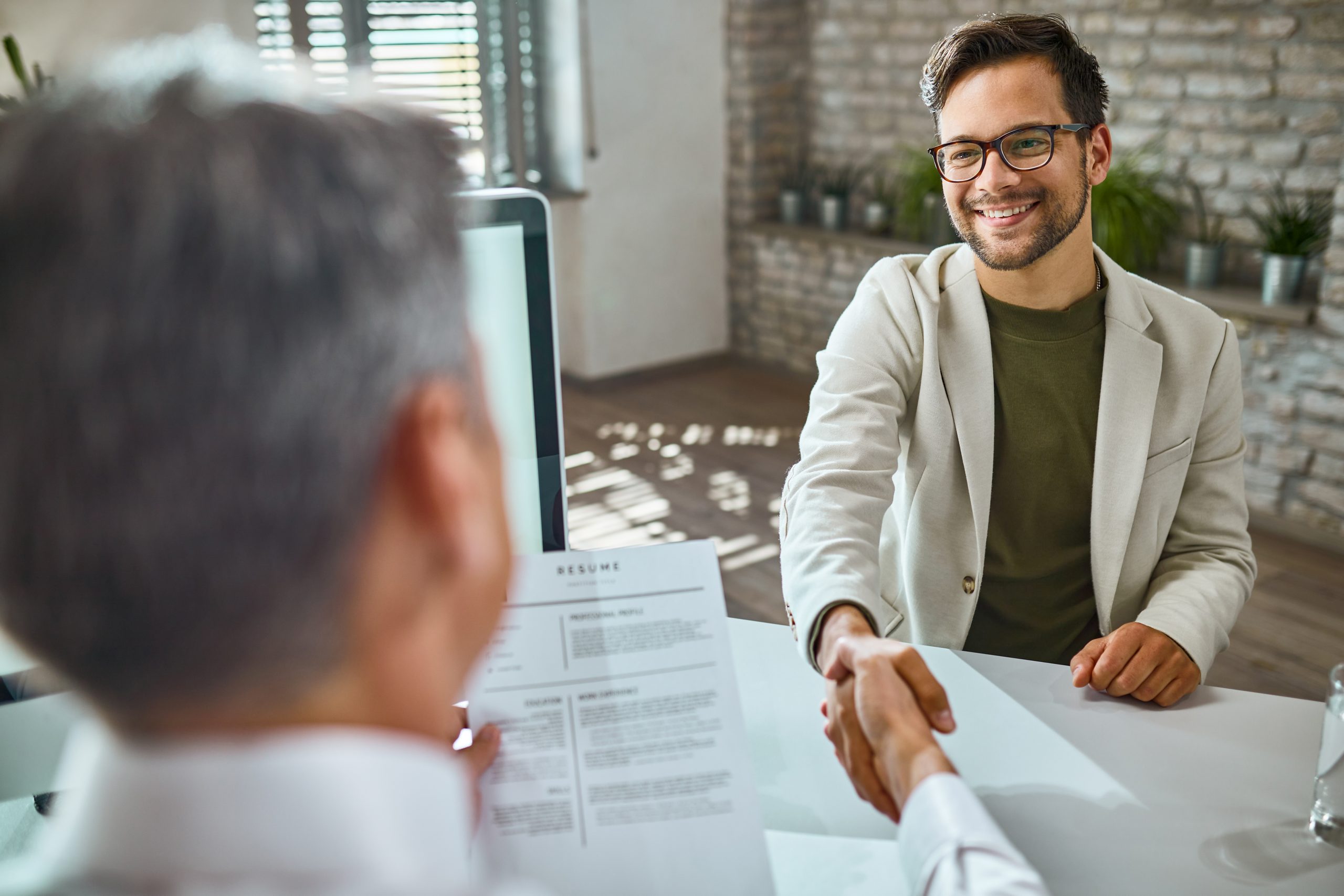 Candidate greeting HR on a job interview in the office