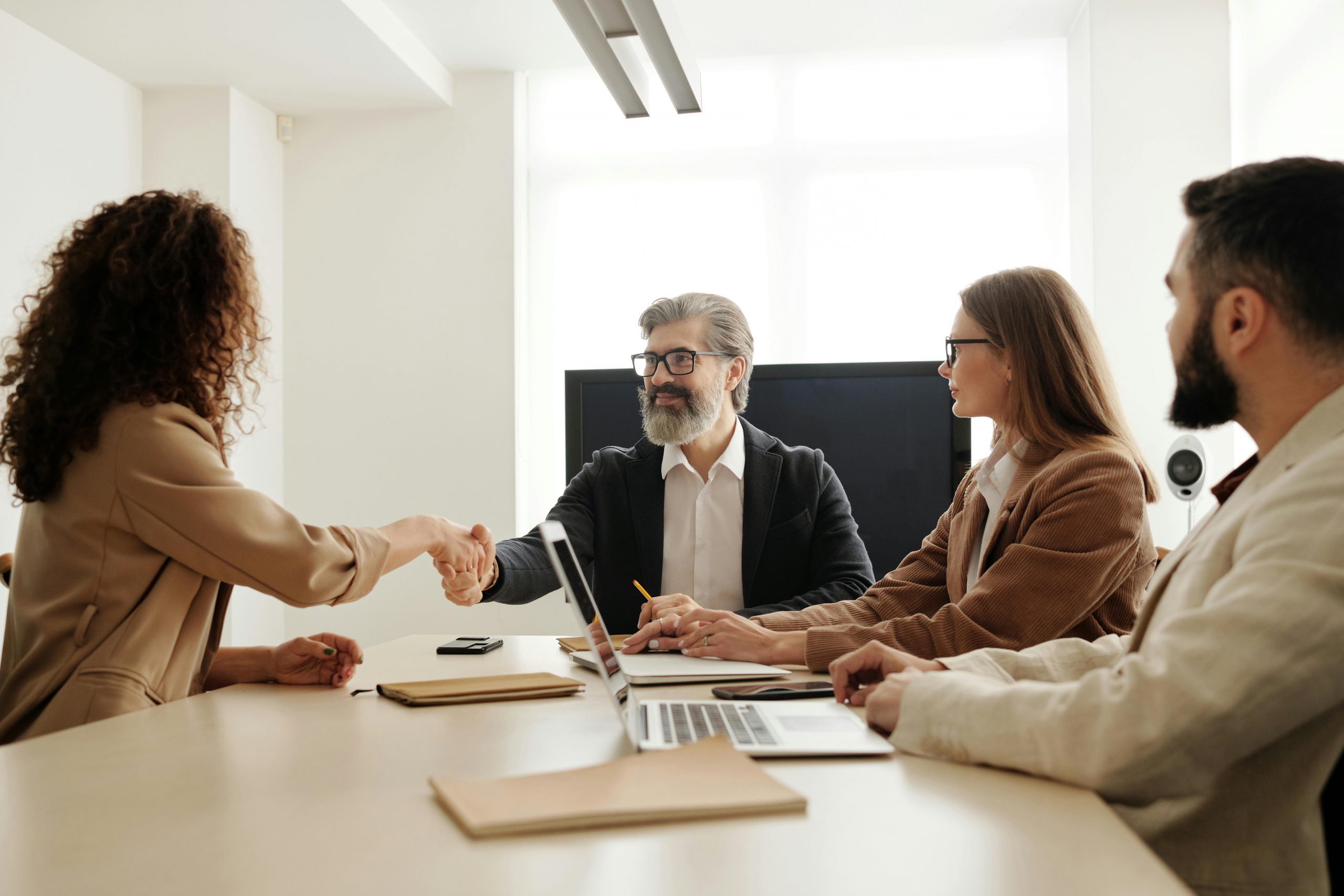 Candidate shaking hands with recruitment panel