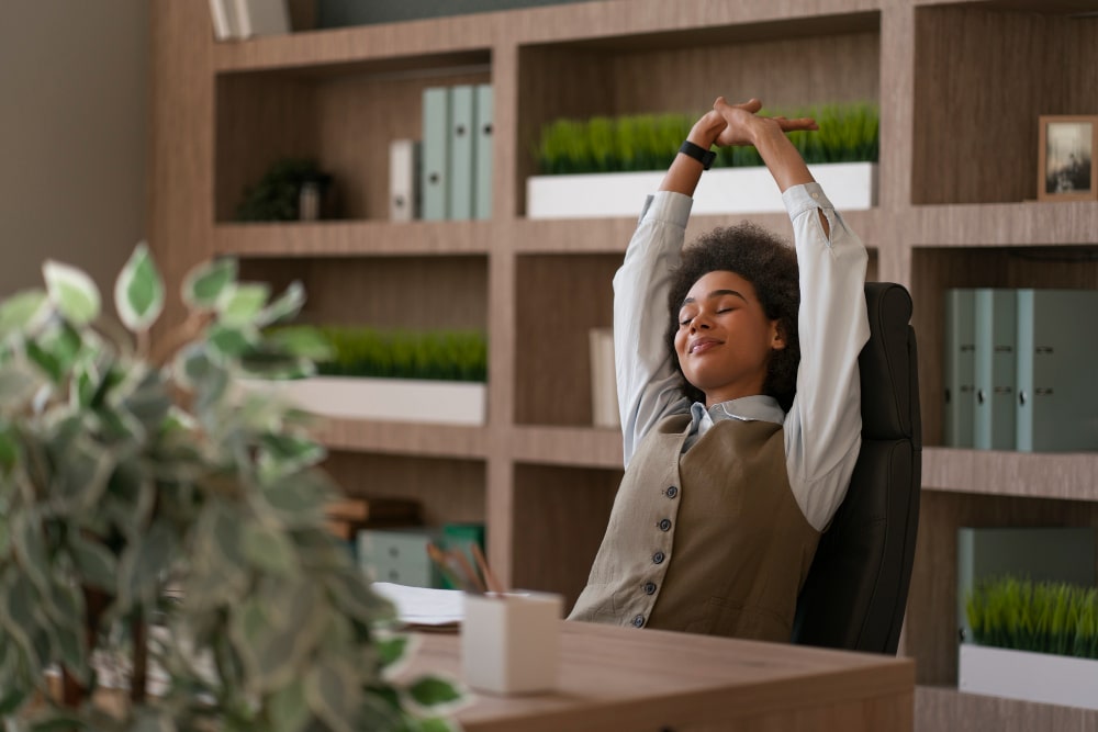 Employee streching while sitting in office